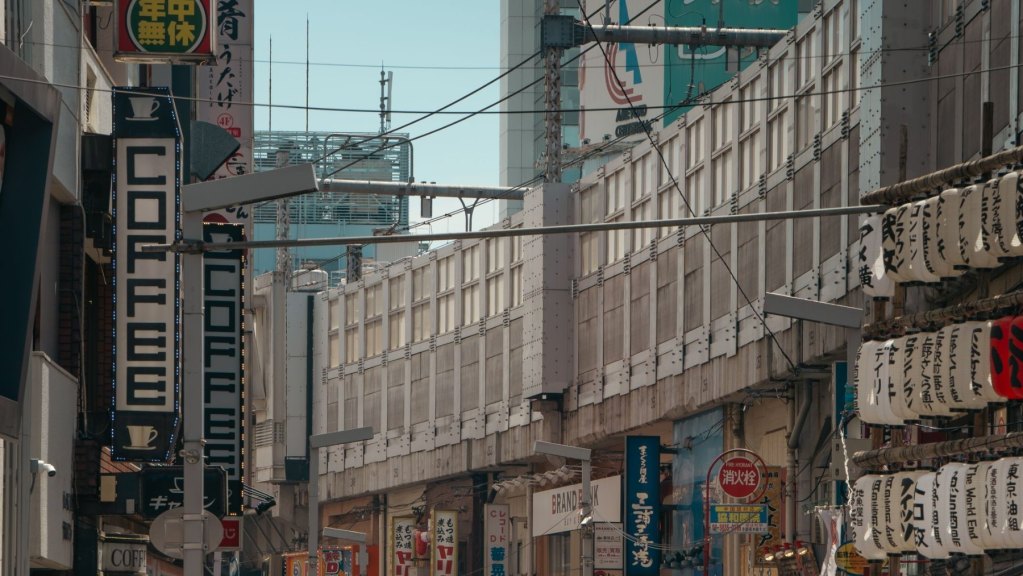 Things to do in Tokyo: explore a busy street lined with shops and signs