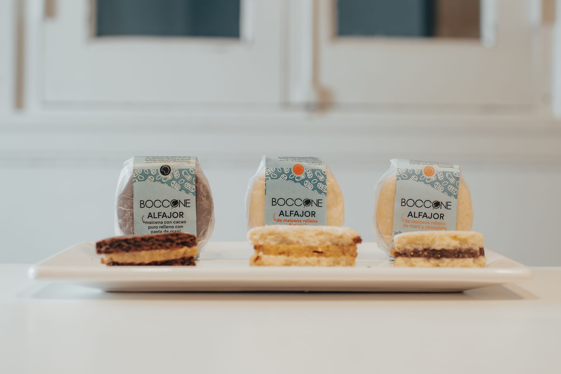 Three alfajores filled with dulce de leche on a plate