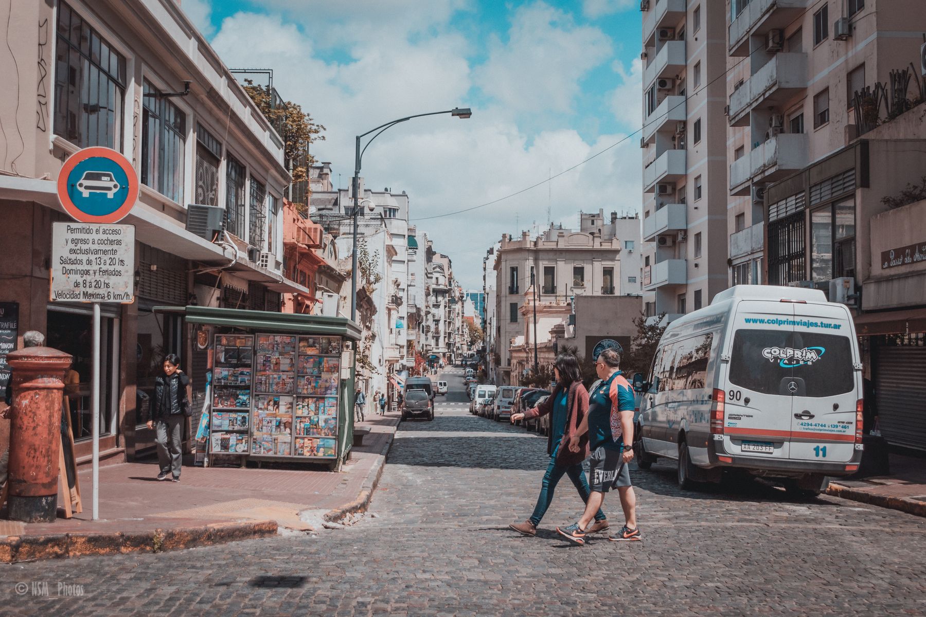 Buenos Aires food guide: pedestrians crossing a cobblestone city street