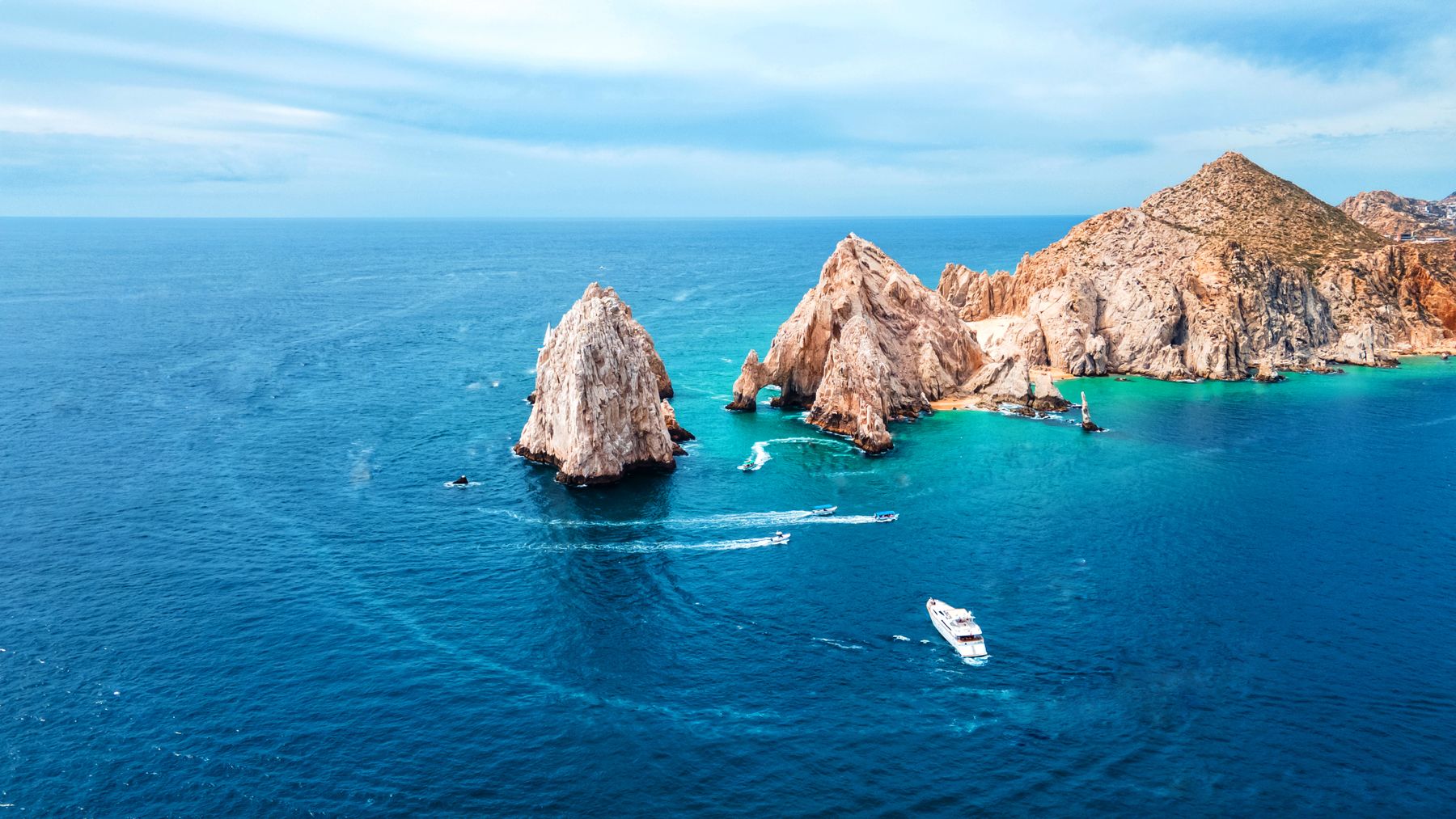 Aerial view of the Cabo San Lucas Arch with boats in the blue water below