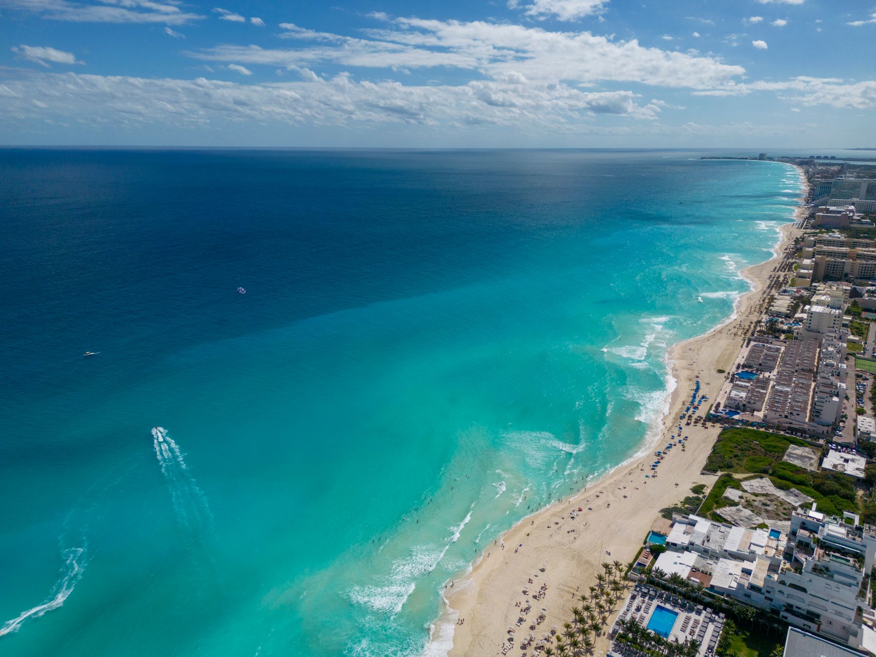 Aerial view of Cancun turquoise water and sandy beach lined with hotels