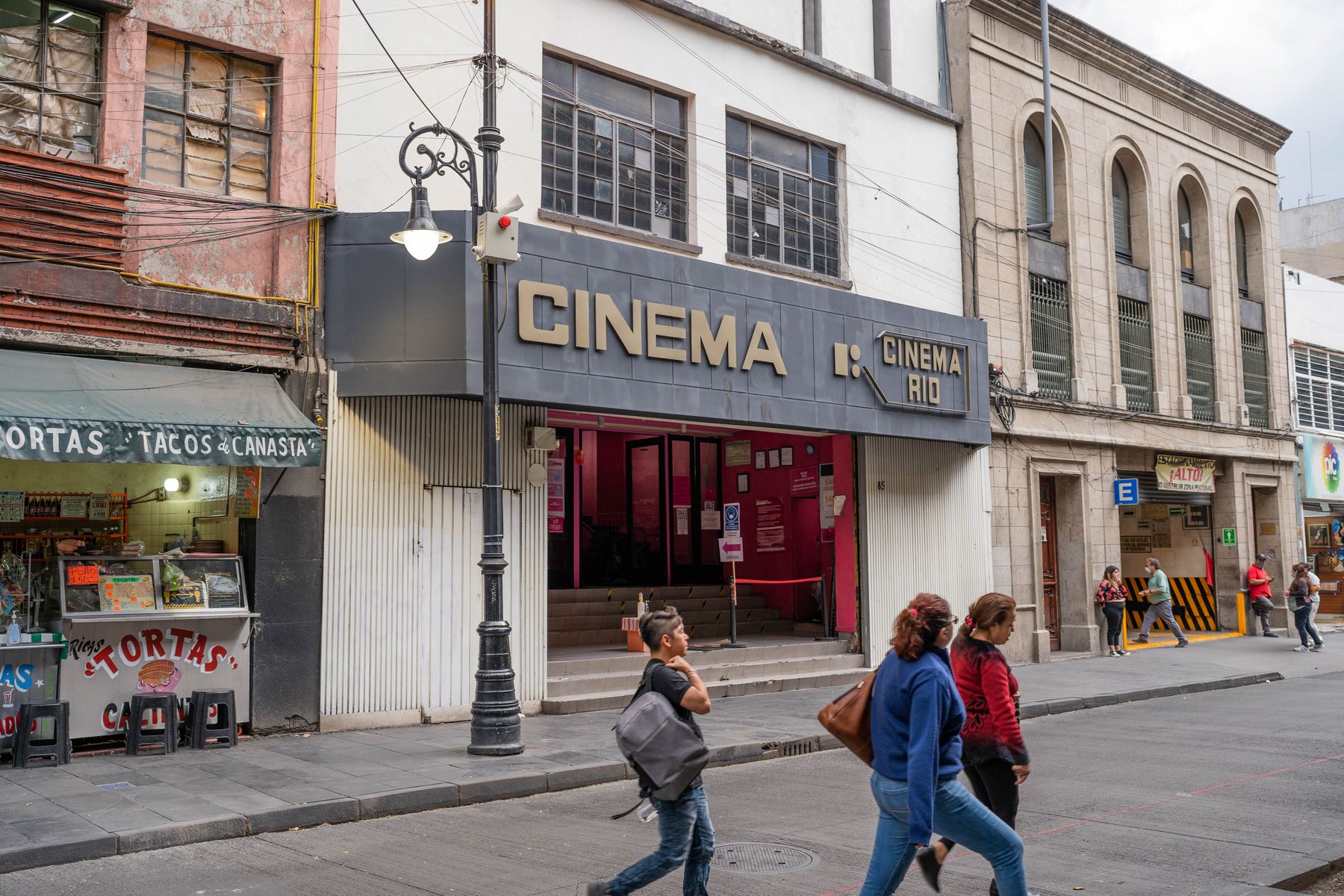 Cinema Rio and local shops on a bustling street in Mexico City