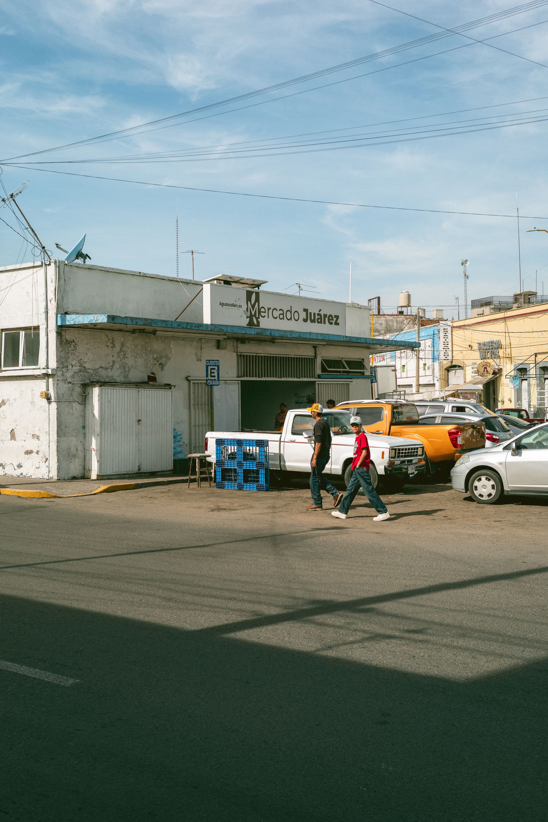 People and cars outside Mercado Juarez in Mexico City on a sunny day