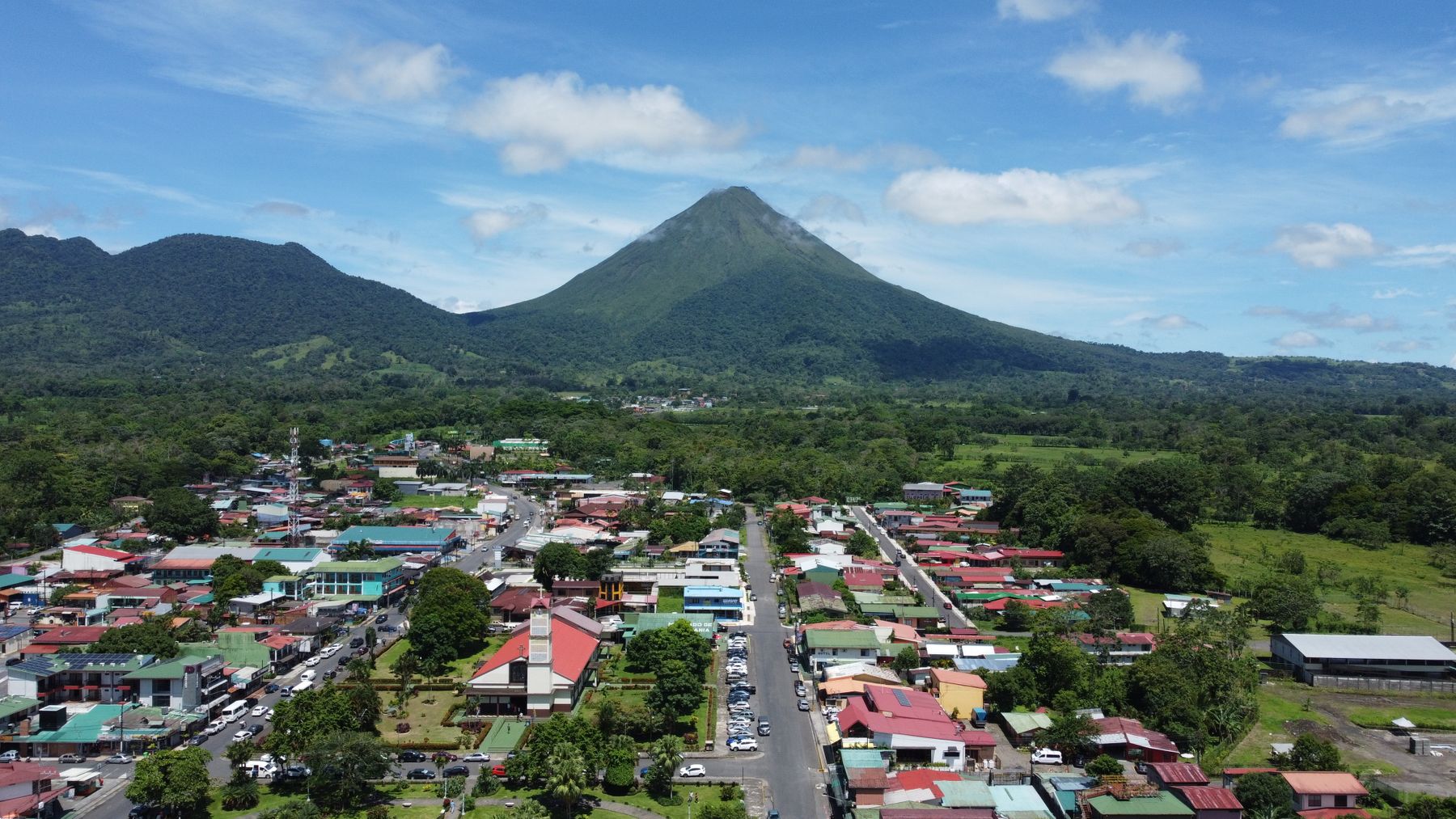Aerial view of La Fortuna with the Arenal Volcano rising behind it in Costa Rica