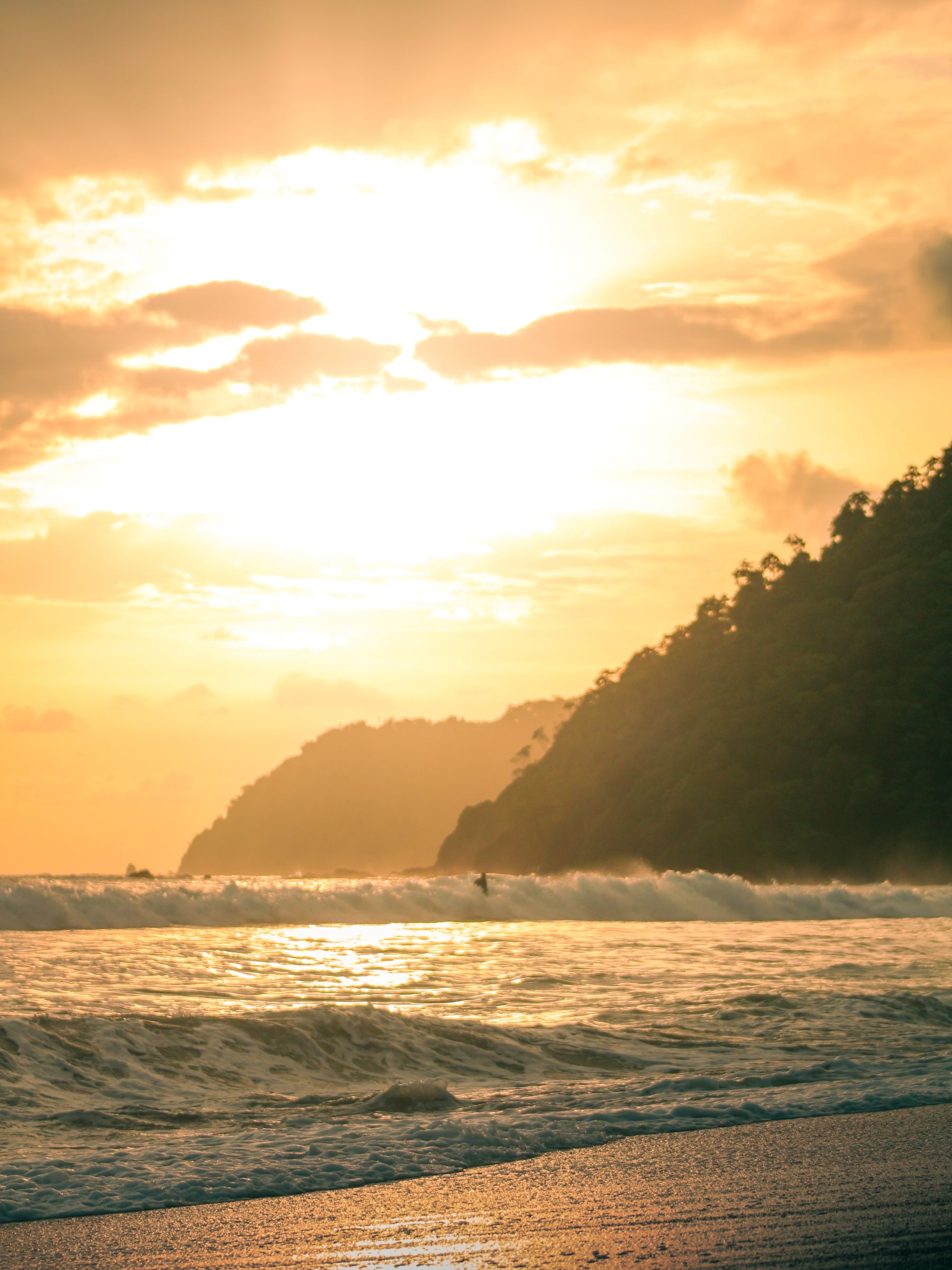 Sunset over a tropical Costa Rica beach with waves breaking on the shore