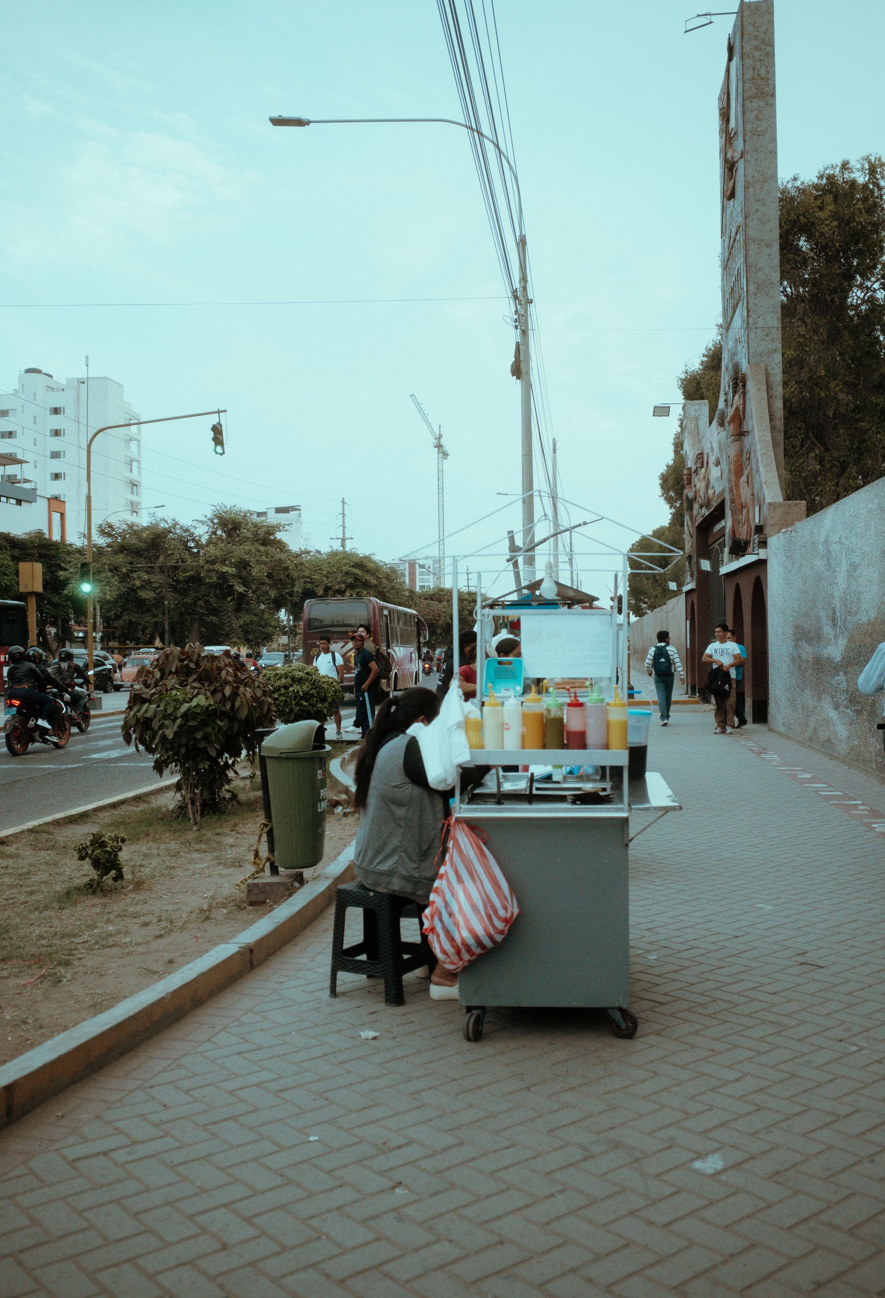 A street vendor selling drinks on a busy day in Peru