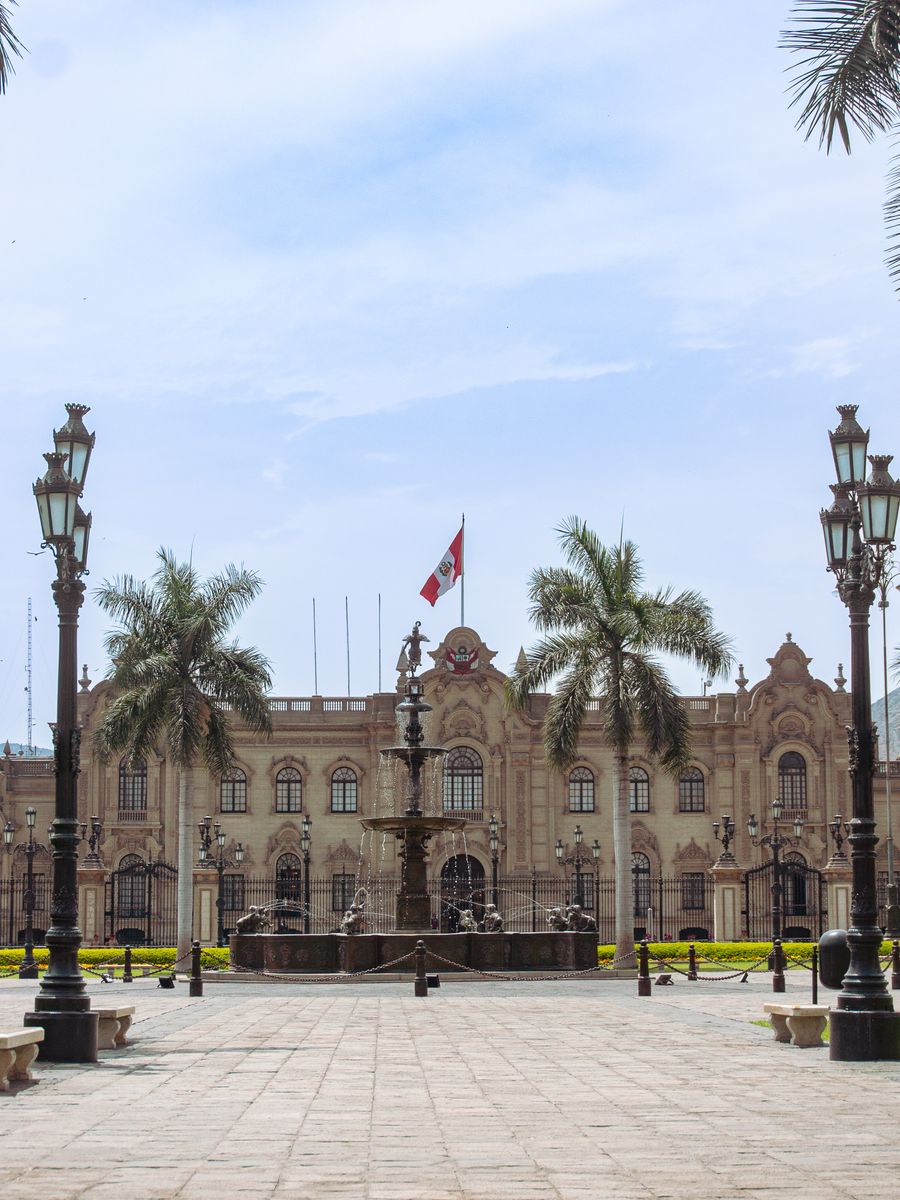 Lima’s Government Palace with palm trees and a fountain in the plaza