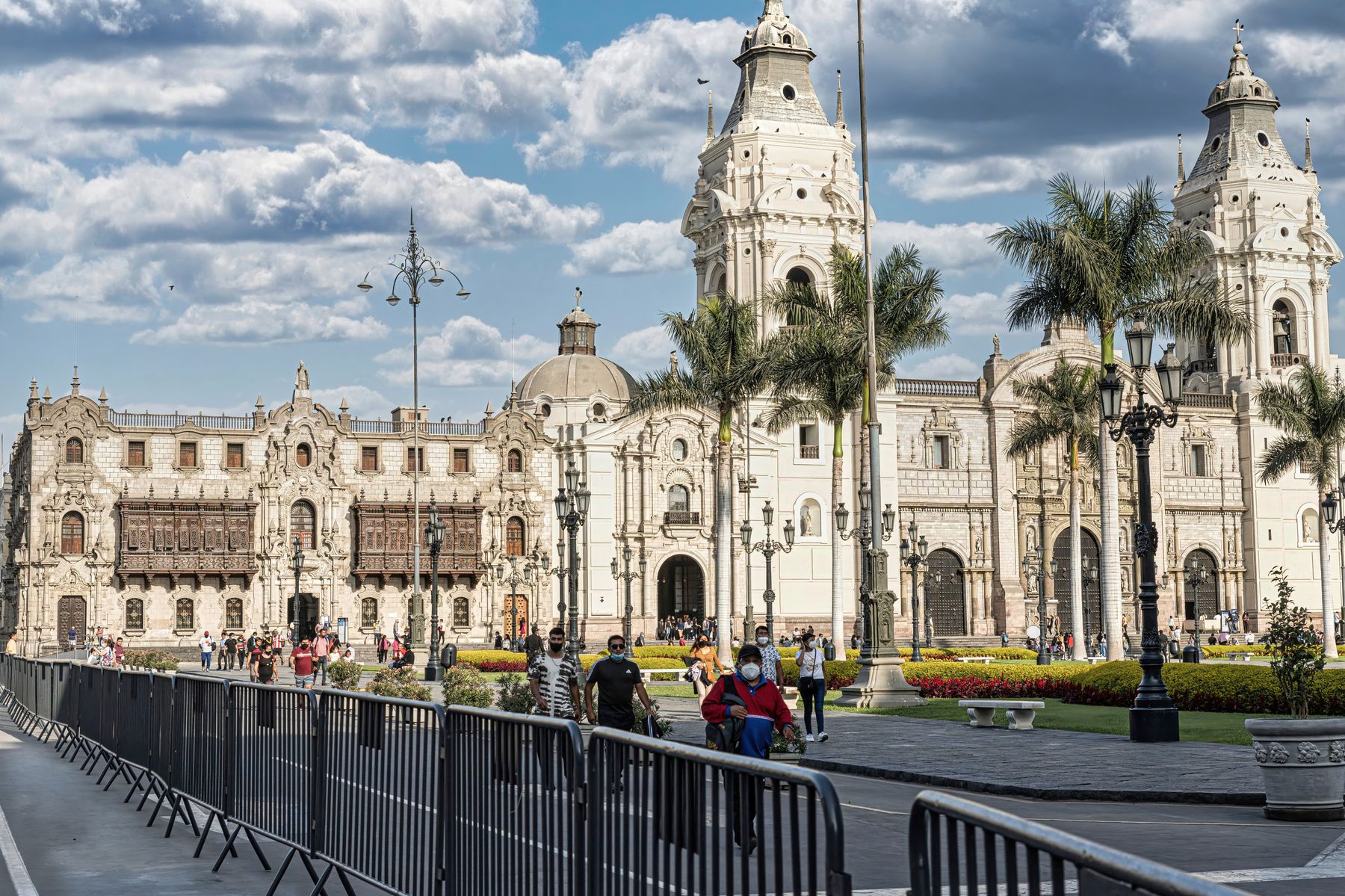 A busy Plaza Mayor in Lima with the historic Cathedral under a blue sky
