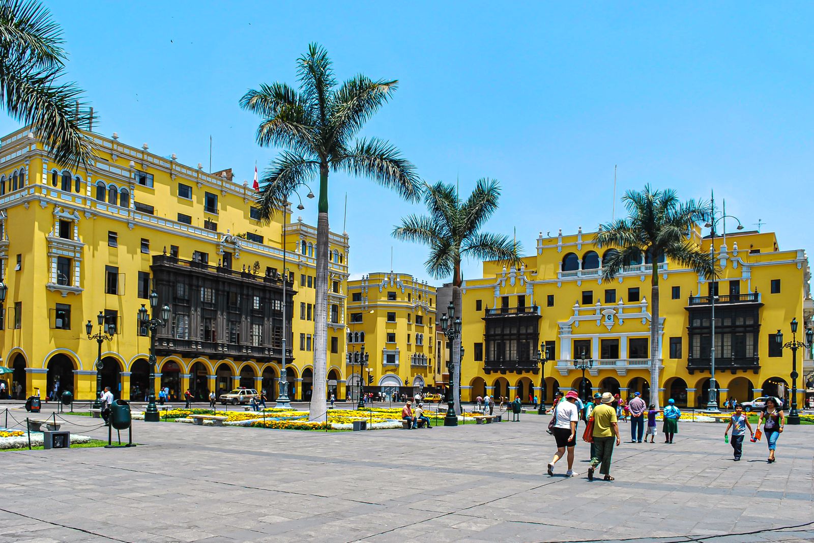 A busy day on Plaza Mayor in Lima with colonial architecture and crowds