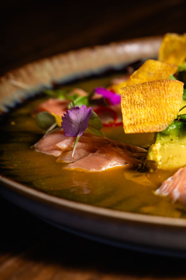 Gourmet ceviche with fish, edible flowers and plantain crisps