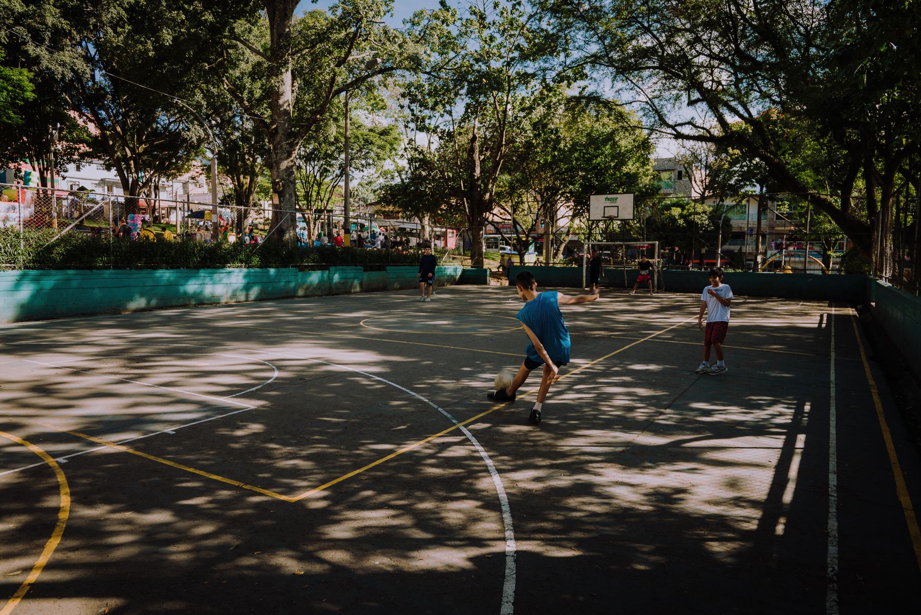 Young people playing football on a neighborhood court in Medellín