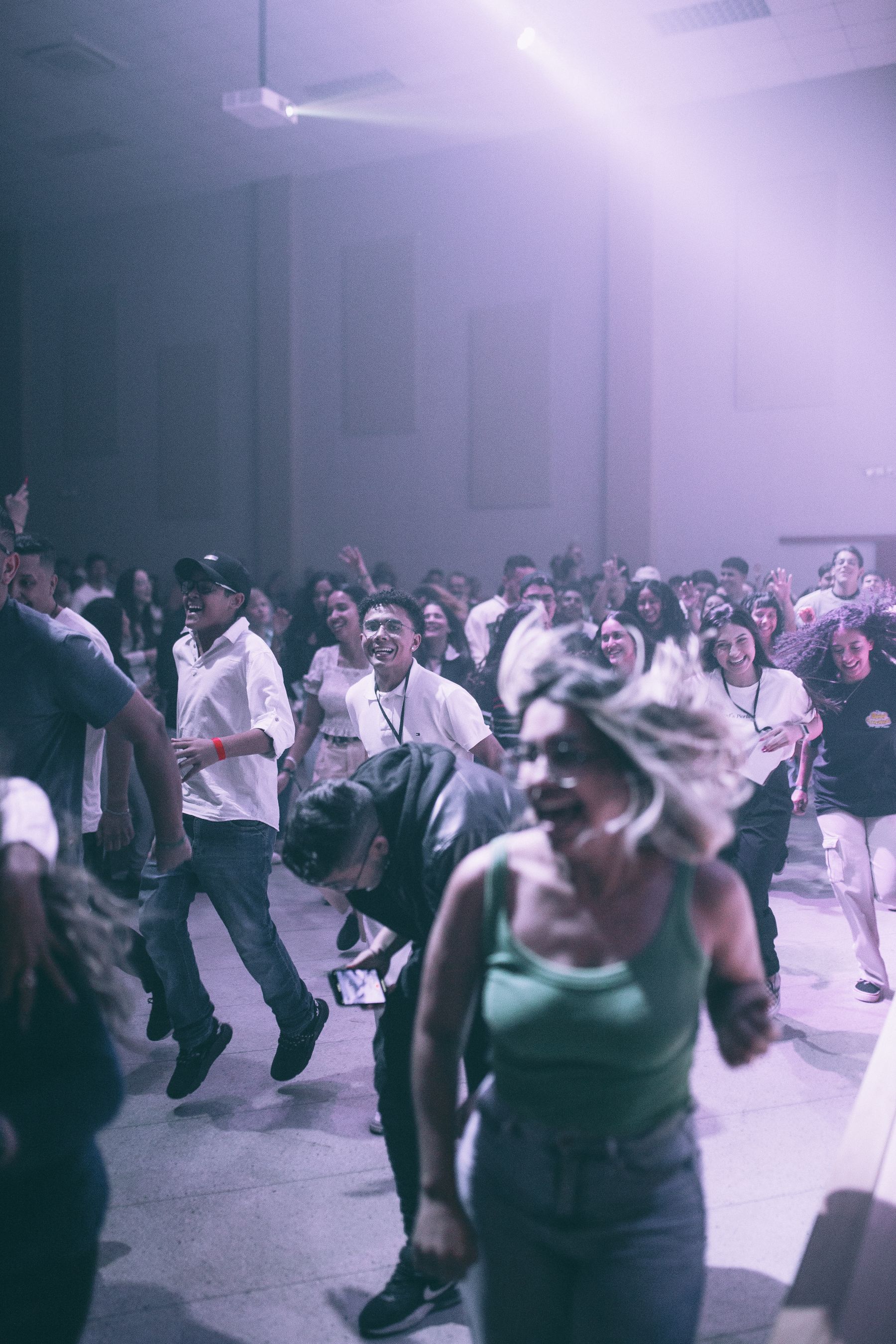 A room full of people dancing together