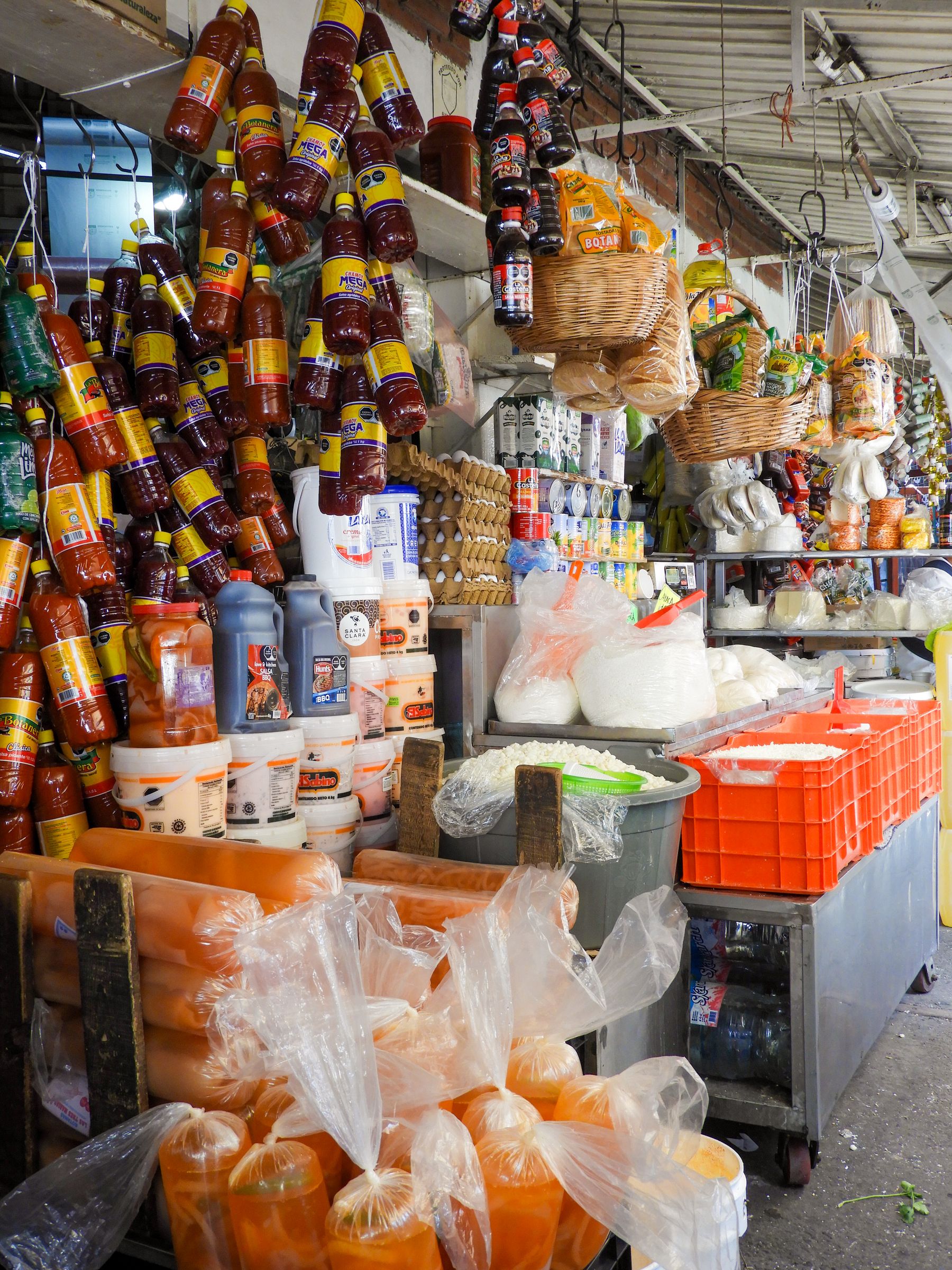 A colourful Mexican market stall of spices, sauces and traditional foods