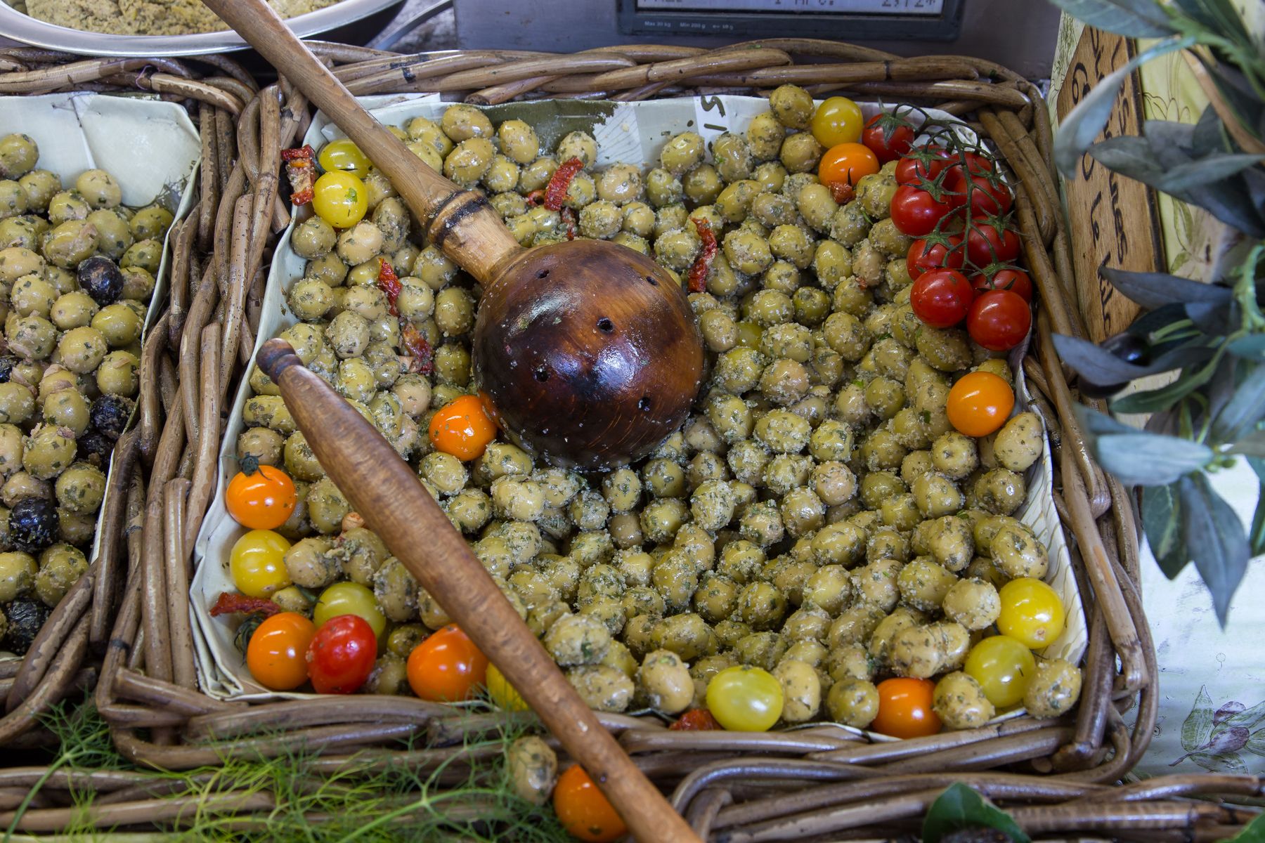 Olives and cherry tomatoes laid out on a village market table