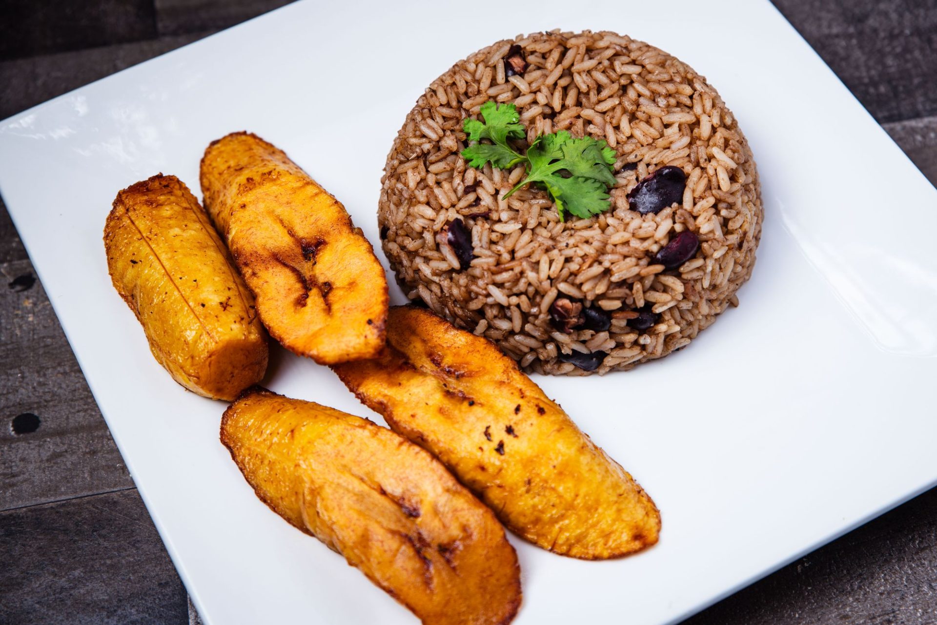 A plate of rice and beans with fried plantains