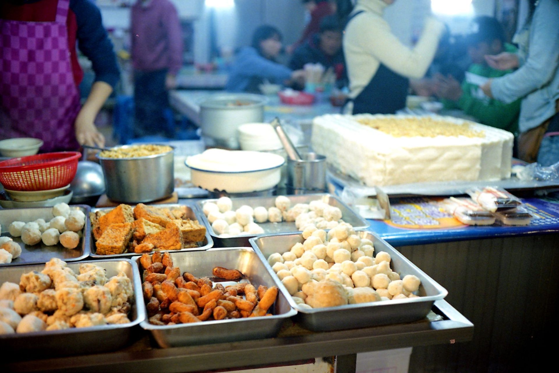 Plates spread across a shared table at a food centre