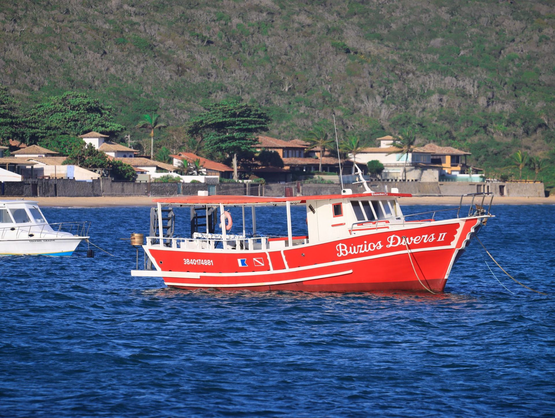 A boat waiting offshore to take passengers across