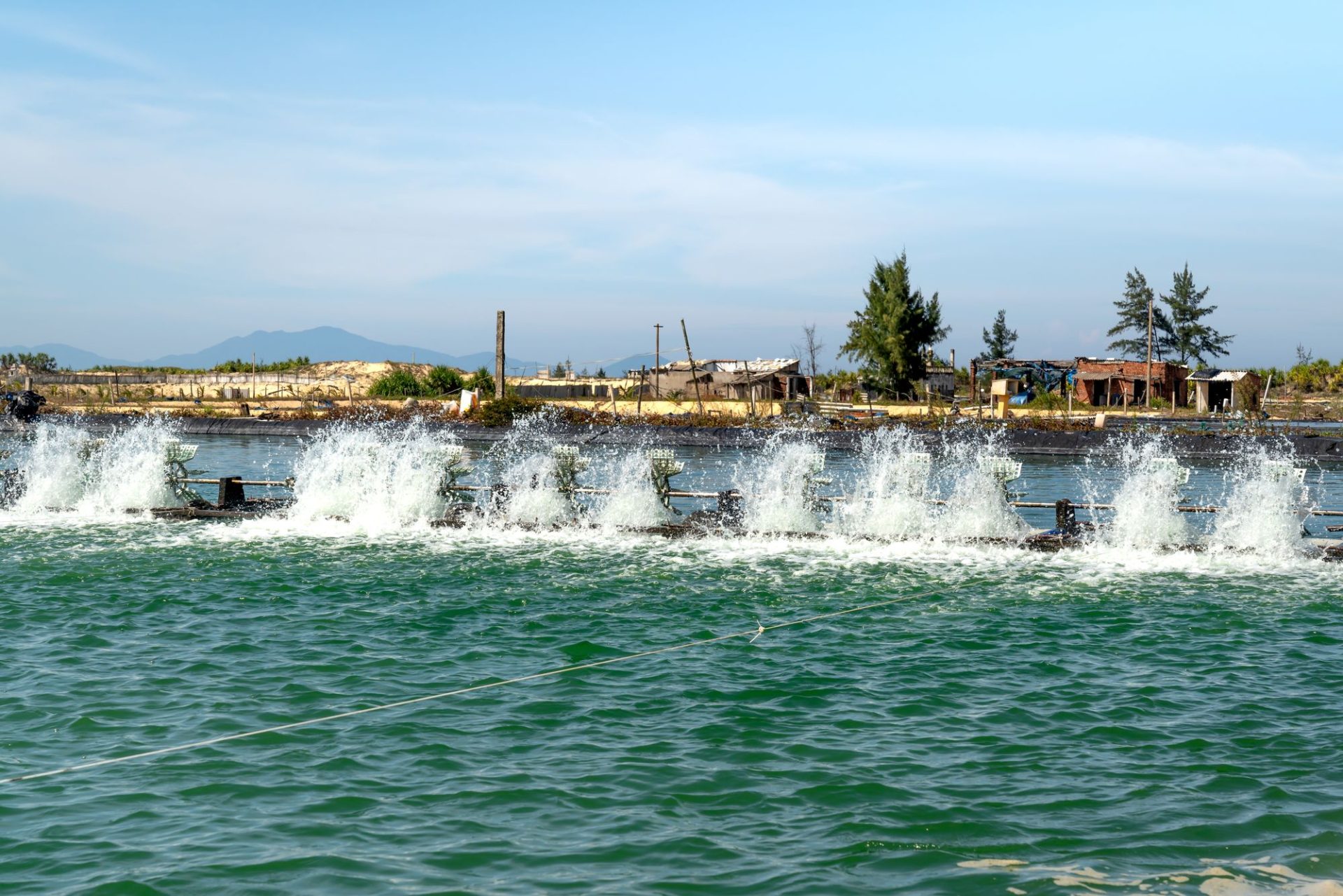 Huts on stilts above a shallow lagoon
