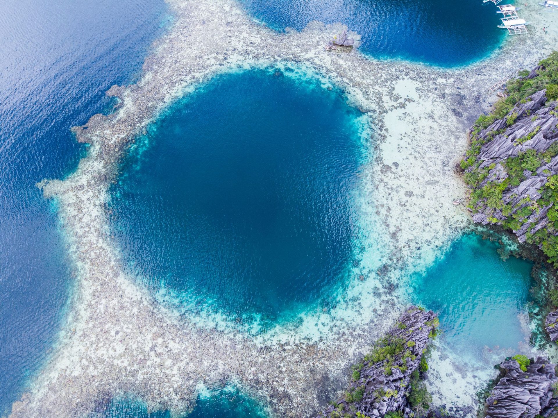 A deep lagoon ringed by rock, reachable only by boat