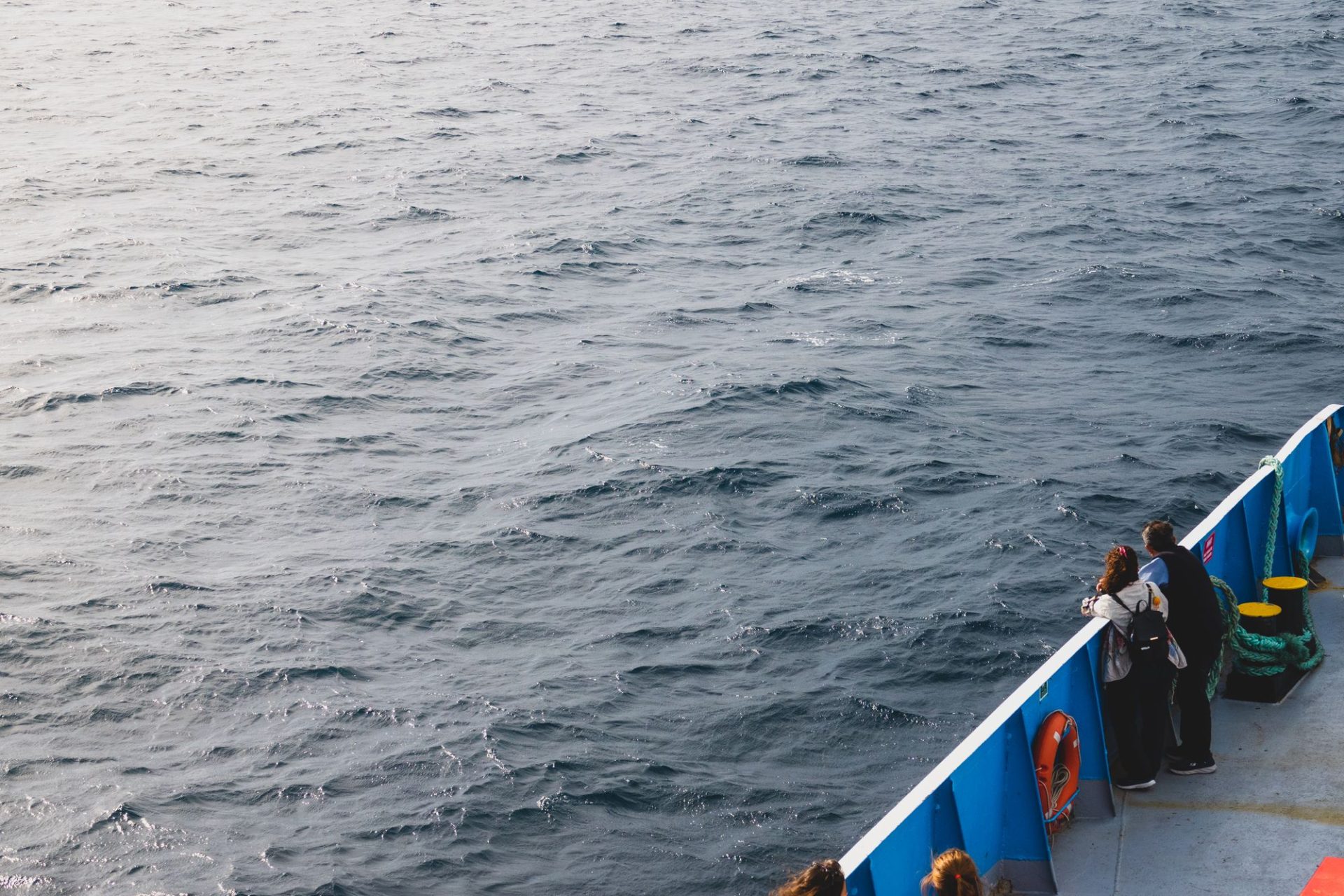 The rail of a boat crossing open water