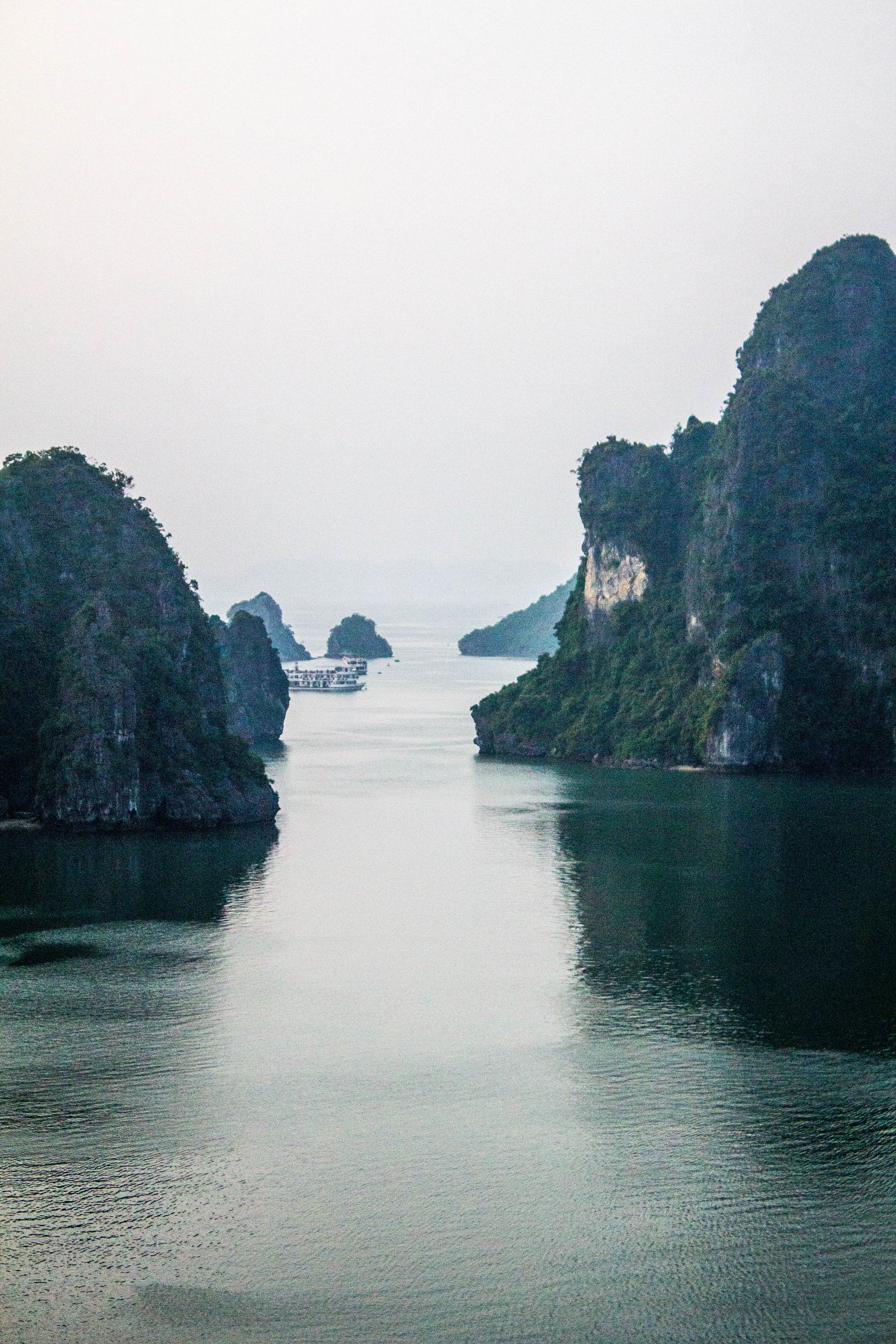 Limestone karsts rising from calm water in northern Vietnam