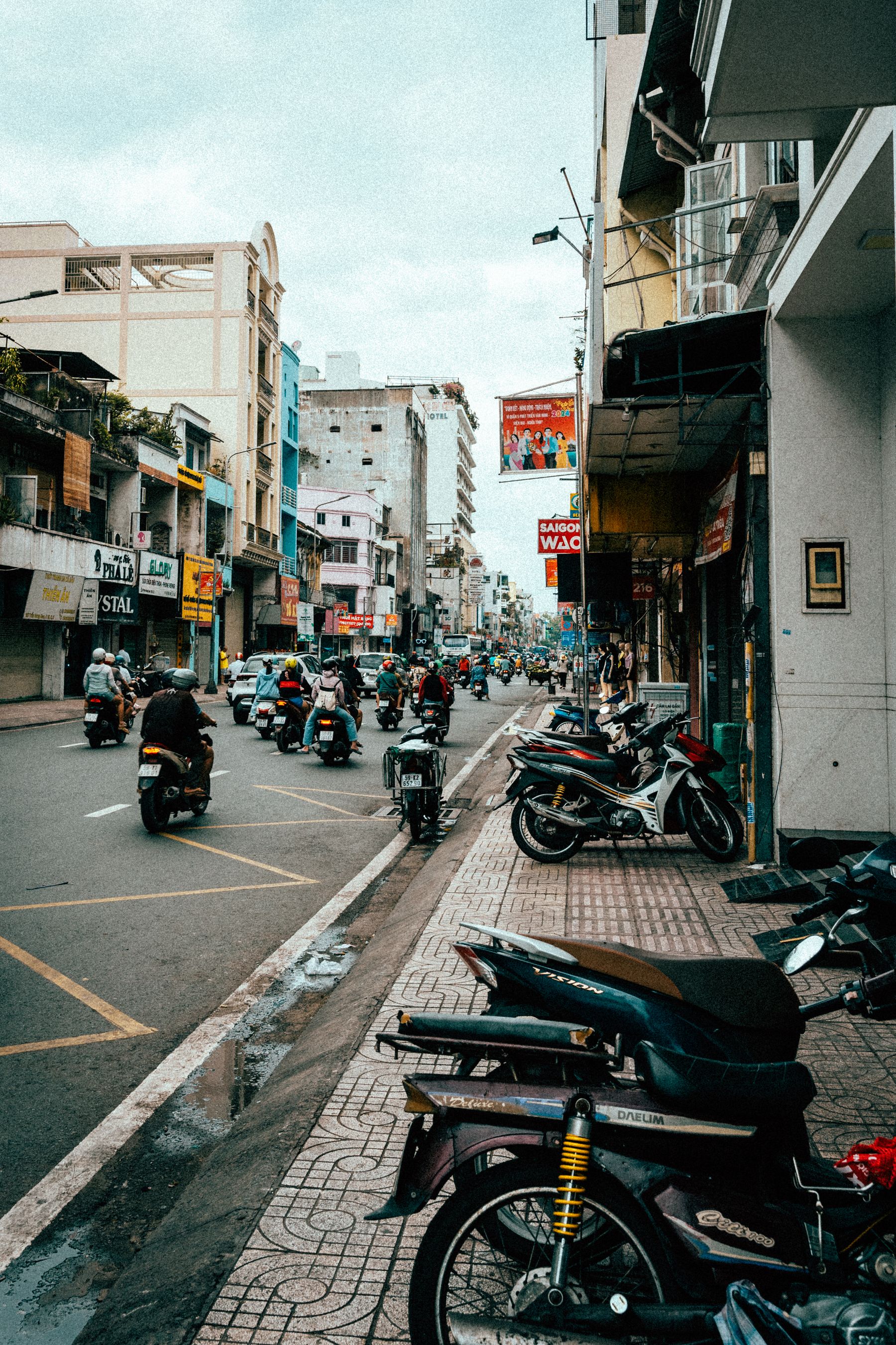 Scooters parked in a row along a city street
