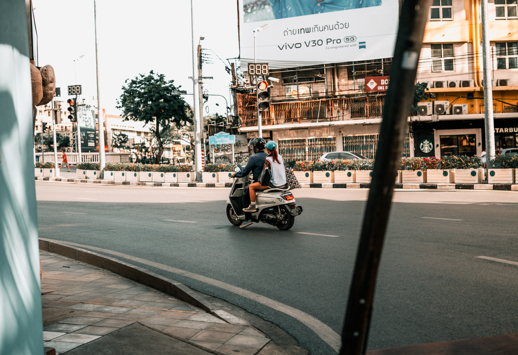 A scooter rider on an open road in Southeast Asia