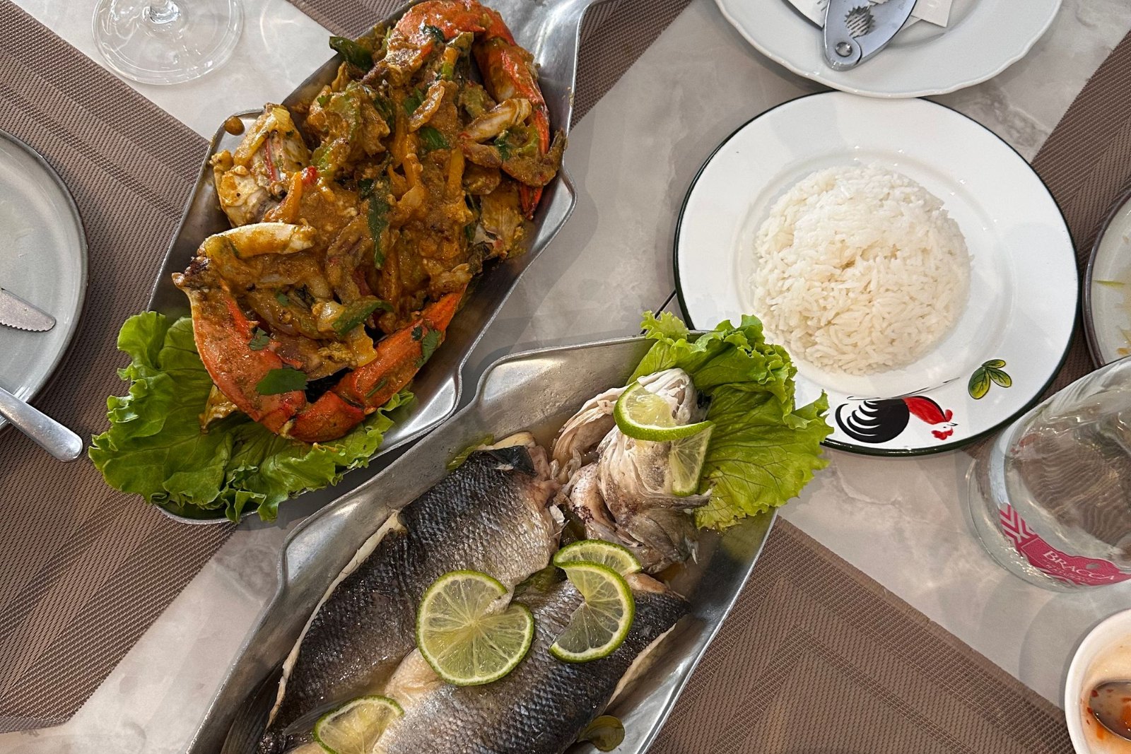 Grilled seafood arriving at a pavement table